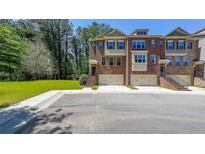 A charming row of brick townhomes featuring private garages and well-manicured lawns at 3155 Boldmere Se Trl # 3, Smyrna, GA 30080