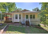 Charming one-story home with a covered porch and lush landscaping at 2528 Mulberry Rock Rd, Dallas, GA 30157