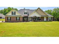 Charming single story brick home with well-manicured lawn and mature landscaping at 330 Pitts Chapel Rd, Newborn, GA 30056