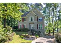 Charming two-story home with red shutters surrounded by mature trees at 3945 Lorien Way, Kennesaw, GA 30152