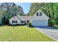 Charming one story home featuring an attached garage and a well maintained lawn and landscape at 4735 Rabbit Farm Rd, Loganville, GA 30052
