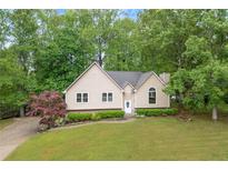 Charming single-Gathering home with a well-manicured lawn and lush trees surrounding the property at 4618 Barkley Nw Dr, Acworth, GA 30101