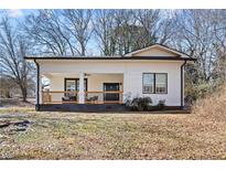 Charming single-story home featuring a covered front porch with traditional architectural details at 3595 South Nw St, Duluth, GA 30096