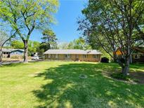 Charming single-story home with brick facade and a spacious, well-manicured front lawn at 2266 Eastgate Dr, Snellville, GA 30078