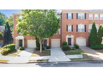 Brick townhouse with manicured landscaping, attached garages, and inviting front entrances at 2324 Towneheights Se Ter # 11, Atlanta, GA 30339