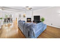 Bright open living room features hardwood floors, a cozy fireplace, and plenty of natural light at 2324 Towneheights Se Ter # 11, Atlanta, GA 30339