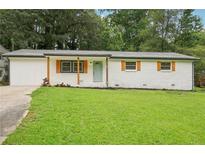Charming brick ranch-style home featuring a well-manicured lawn and inviting curb appeal at 2450 Elkhorn Dr, Decatur, GA 30034