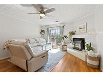 Inviting living room featuring a ceiling fan, fireplace, a sliding door, and stylish decor at 970 Sidney Marcus Ne Blvd # 2408, Atlanta, GA 30324