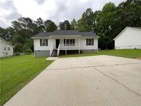 Charming single-story home with white siding, red shutters, and a spacious concrete driveway at 45 Carroll St, Temple, GA 30179
