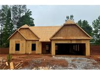 Exterior of new construction home shows the framing and garage; awaiting finishing and personalization at 490 Charleston Pl, Villa Rica, GA 30180