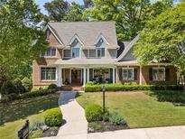 Charming two-story home with a beautifully landscaped front yard and a welcoming entrance at 1050 Signal Pointe, Alpharetta, GA 30005