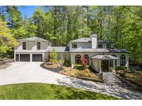 Stunning home exterior with manicured lawn, driveway, and attached garage at 4067 Randall Farm Se Rd, Atlanta, GA 30339
