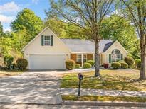 Charming single-Gathering home with a well-manicured lawn and attached two-car garage at 823 Langley View Ct, Loganville, GA 30052