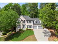 Charming two-story home with well-maintained landscaping and a three-car garage at 11060 Pennbrooke Xing, Johns Creek, GA 30097