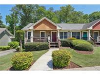Charming home featuring a landscaped front yard and a cozy front porch at 734 Frasier Se Cir, Marietta, GA 30060