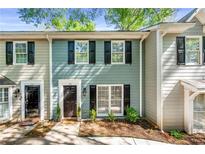 Charming two-story townhouse with black shutters and manicured landscaping at 113 Courtyard Ter, Roswell, GA 30075