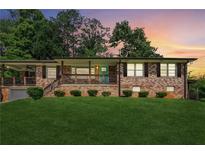 Charming brick home with a covered porch and well-maintained lawn at 1652 Detroit Nw Ave, Atlanta, GA 30314