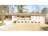 Charming single-story brick home featuring a front porch and manicured landscaping at 1652 Detroit Nw Ave, Atlanta, GA 30314