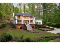 Inviting two-story home with a double balcony, grand staircase, and mature landscaping at 4094 Norton Se Pl, Smyrna, GA 30082