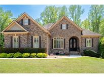 Charming brick home boasts a manicured lawn, beautiful landscaping, and inviting curb appeal at 3053 Lawson Dr, Marietta, GA 30064
