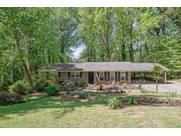 Charming brick home with a well-manicured lawn and beautiful landscaping at 3139 Mary Dr, Marietta, GA 30066