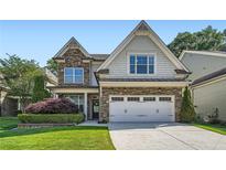 Charming two-story home with stone accents, manicured landscaping, and an attached two-car garage at 3699 School Street, Chamblee, GA 30341