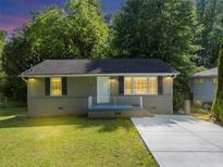 Charming home featuring a well-maintained lawn, gray painted brick foundation and concrete driveway at 1677 Wayland Ne Cir, Brookhaven, GA 30319