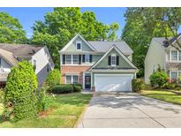 Charming two-story home with a well-manicured lawn, brick accents, and a two-car garage at 335 Pintail Ct, Suwanee, GA 30024