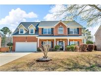Charming two-story red brick home with a well-manicured lawn and attached two-car garage at 362 Interlake Pass, Mcdonough, GA 30252