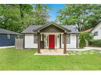 Charming home featuring a well-manicured lawn, stone walkway, and a vibrant red front door at 360 New Jersey Nw Ave, Atlanta, GA 30314