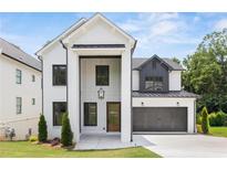 New construction home with painted brick, modern design, and professional landscaping at 267 Green Hill Rd, Sandy Springs, GA 30042