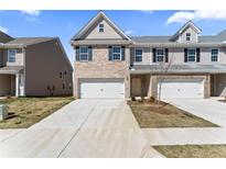 Charming two-story townhome with brick and siding, a driveway, and an attached single-car garage at 2861 Fareed, Douglasville, GA 30135
