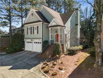 Charming two-story home features a two-car garage, a red front door, and a well-maintained front yard at 5 Renfroe Ct, Decatur, GA 30030