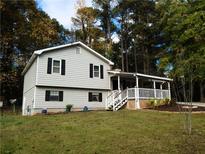 Charming two-story home with well-maintained lawn, dark shutters, and covered porch at 727 Regina Ct, Lawrenceville, GA 30043