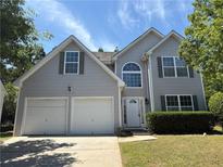 Charming two-story home featuring a two-car garage, beautiful architectural features, and manicured landscaping at 4234 Winston Cir, Atlanta, GA 30349