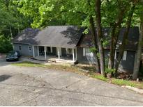 Charming single-story home with a covered front porch and mature trees at 165 Holly Ct, Loganville, GA 30052