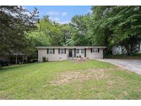 Charming home with a well-maintained front yard and classic ranch architecture at 310 Oak Se Dr, Atlanta, GA 30354