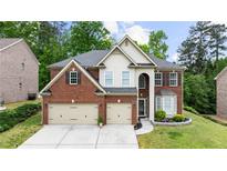 Beautiful two-story brick home with a well-manicured lawn and a three-car garage at 5484 Stone Cove Sw Dr, Atlanta, GA 30331