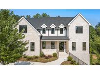 Striking exterior view of a two-story brick home with black trim and manicured landscaping at 117 Owens Mill Pl, Canton, GA 30115