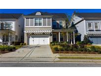 Charming two-story home featuring a brick facade, white trim, and a well-manicured front yard at 2262 Haventree Ct, Lawrenceville, GA 30043