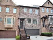 Charming brick townhome with stone accents, inviting entrance, and attached two-car garage at 1032 Willow Field Se Ln # 17, Marietta, GA 30067