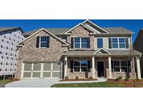 Beautiful two-story brick home with a covered porch and a two-car garage, perfect for suburban living at 3325 Linstead Ct, Loganville, GA 30052