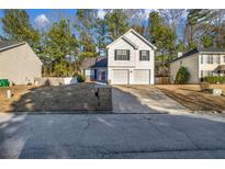 Charming two-story home with a two car garage and well-maintained front yard in a suburban neighborhood at 939 Redan Trce, Stone Mountain, GA 30088