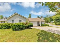 Charming single-story home featuring a well-manicured lawn and beautiful landscaping at 1626 Cobbs Creek Ln, Decatur, GA 30032