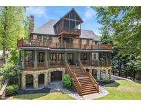 Stunning multi-story home boasts multiple decks, stone accents, and outdoor access at every level at 4290 Bobbins Way, Cumming, GA 30041