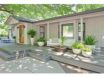 Inviting front porch featuring stylish outdoor seating, decorative plants, and a warm, welcoming entrance at 7580 Blacks Mill Rd, Cumming, GA 30028