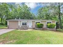 Charming single-story home with stone accents, attached garage, and well-manicured lawn at 5326 Highway 5, Douglasville, GA 30135