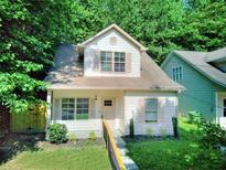 Charming home with a well-maintained lawn and complemented by lush surrounding trees at 70 Gardenia Nw Dr, Atlanta, GA 30314