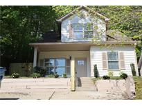 Charming two-story home features a landscaped front yard, neutral tones, and inviting front entrance at 70 Gardenia Nw Dr, Atlanta, GA 30314