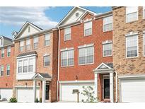 Beautiful brick townhomes with attached garages and well-maintained landscaping at 3505 Chattahoochee Summit Se Ln # 25, Atlanta, GA 30339